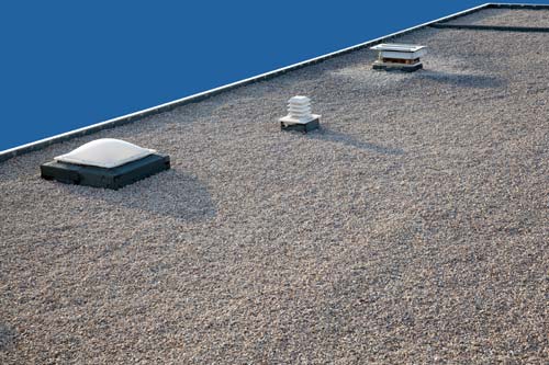 Stone and stucco house with front door pillars. 