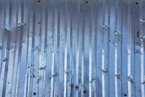 Metal roofing that is dented and damaged.