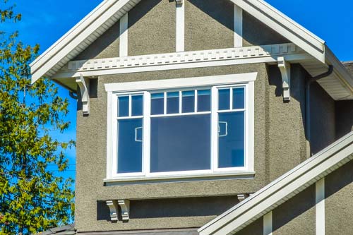 2nd floor window with tan siding aroudn it.